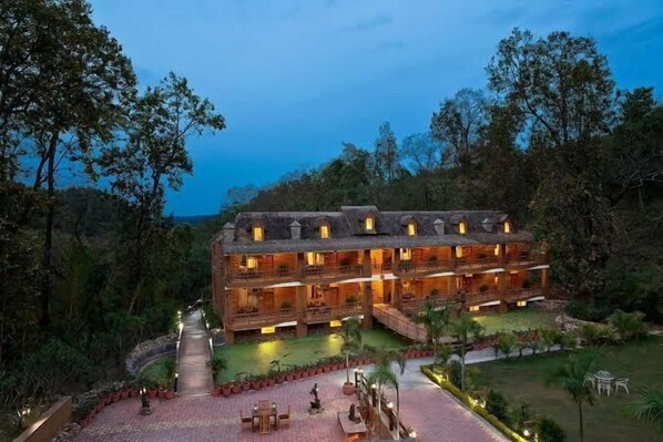 A multi-story hotel with a courtyard, surrounded by trees. - The Rangers reserve Jim Corbett (Nainital)