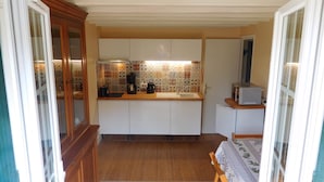 A compact kitchen with white cabinets, a wooden countertop, a coffee maker, and a toaster. - "from one Eure to another" A charming house in a garden (SAINTE GEMME MORONVAL)