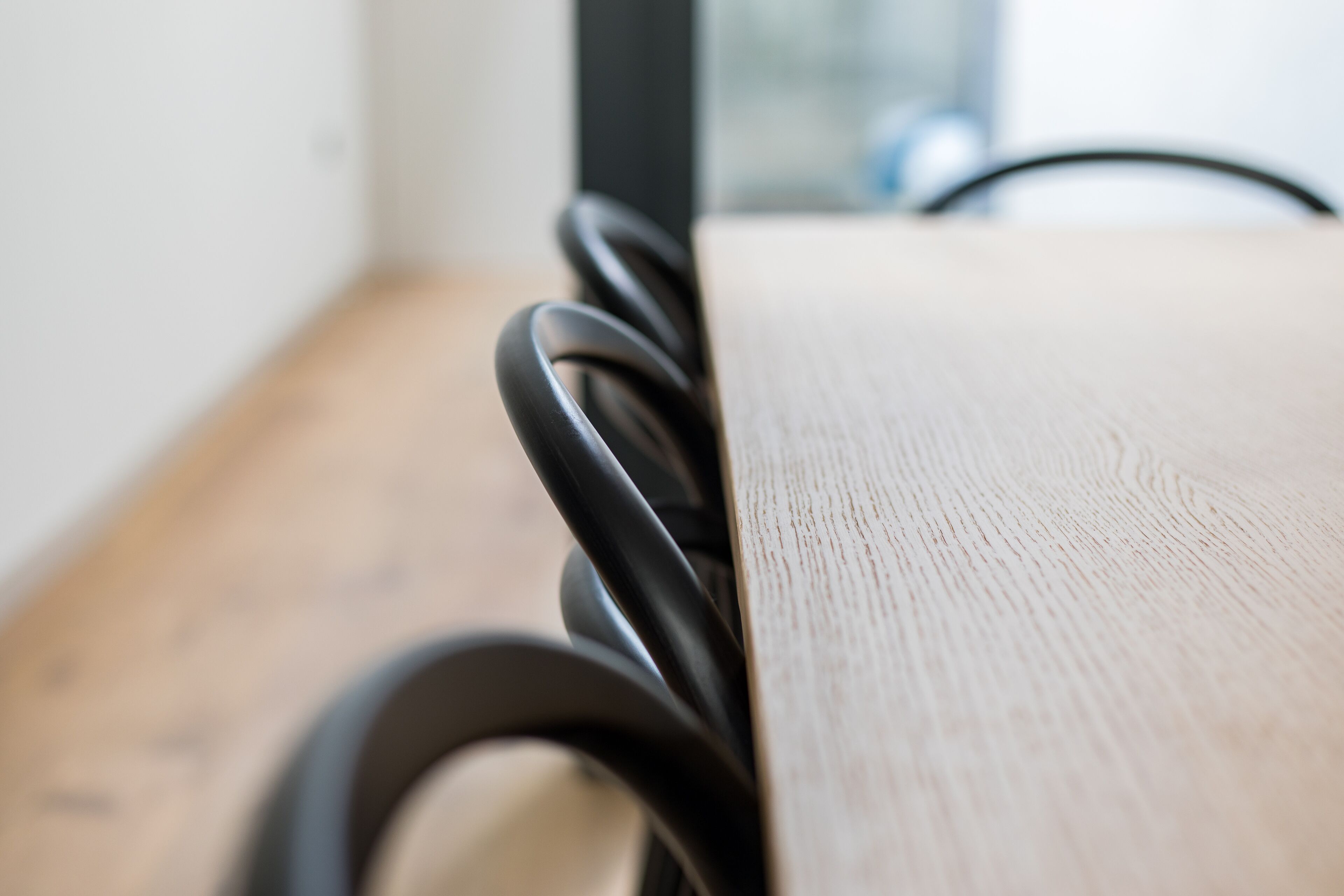 A close-up of a wooden table with a black metal frame.