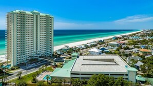 A high-rise hotel with a pool and a beach view.