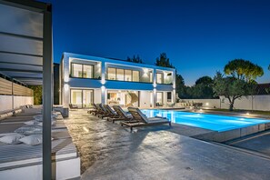 A modern two-story house with a swimming pool, sun loungers, and a covered outdoor seating area. - The Divine Villa of Zakynthos (Zakynthos (Zante))