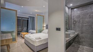 A modern hotel room with a bed, bedside table, and a bathroom with a shower and sink. - The Divine Villa of Zakynthos (Zakynthos (Zante))