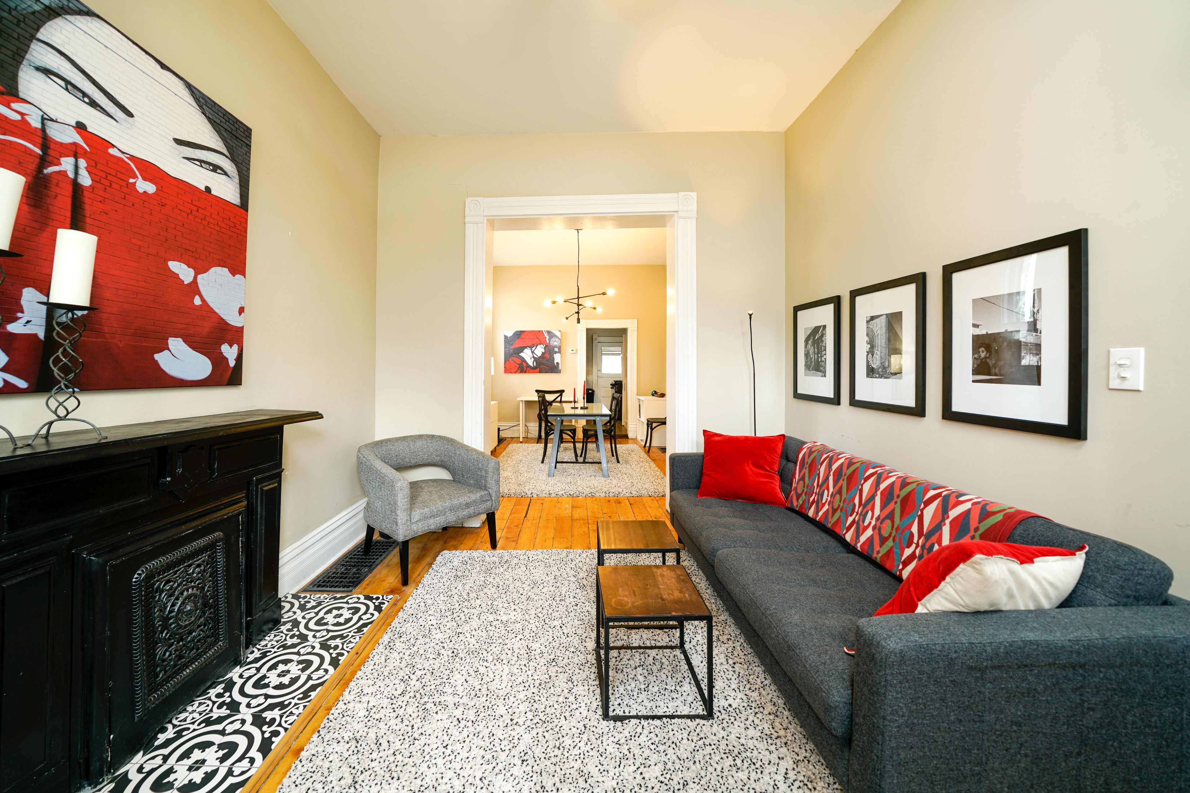 A living room with a fireplace, a sofa, a coffee table, and a patterned rug.