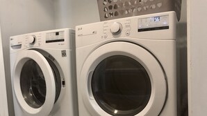 Two front-loading washing machines in a laundry room. -  Charming Country Home — 1,400+ Sq Ft, Minutes from ECU Health (Winterville)
