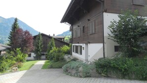 A traditional chalet with a wooden exterior, a stone pathway leading to the entrance, and a mountain backdrop. - Diamant by Interhome (Zweisimmen)