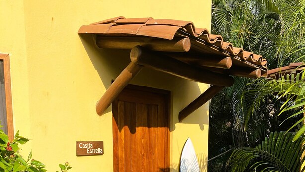 A wooden door with a sign reading "Casita Estrella" and a "Privado" sign indicating private access. - Troncones Point Hostel (Troncones)