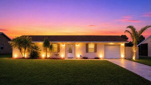 A single-story house with a front entrance, a garage, and a well-maintained lawn.