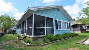 A blue house with a screened porch, number 12, and a well-maintained front yard. - STEPS TO THE SEA AND SAND IN DEWEY BEACH (Dewey Beach)