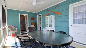 A covered patio with a round table and chairs, a ceiling fan, and a view into the house. - STEPS TO THE SEA AND SAND IN DEWEY BEACH (Dewey Beach)