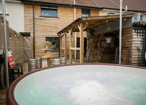 A wooden cabin with a hot tub, wooden deck, and a covered outdoor seating area. - James Place @ Bike Park Wales and The Brecon Beacons (Merthyr Tydfil)