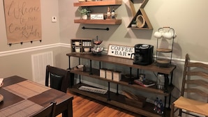 Een rustiek interieur met een boerderijbord, een koffiebar en een welkomstbord.