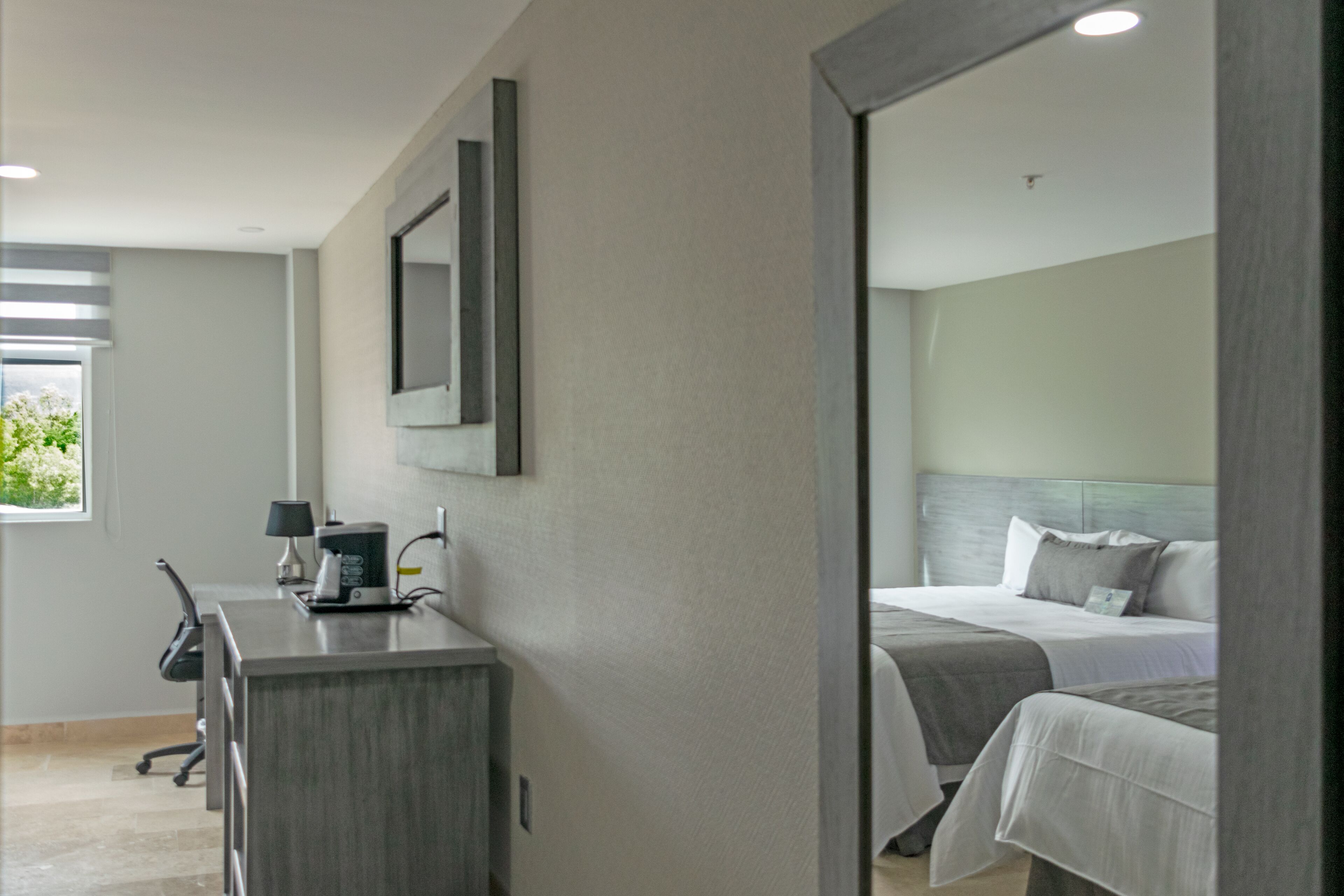 deluxe room, multiple beds | minibar, in-room safe, desk, blackout curtains