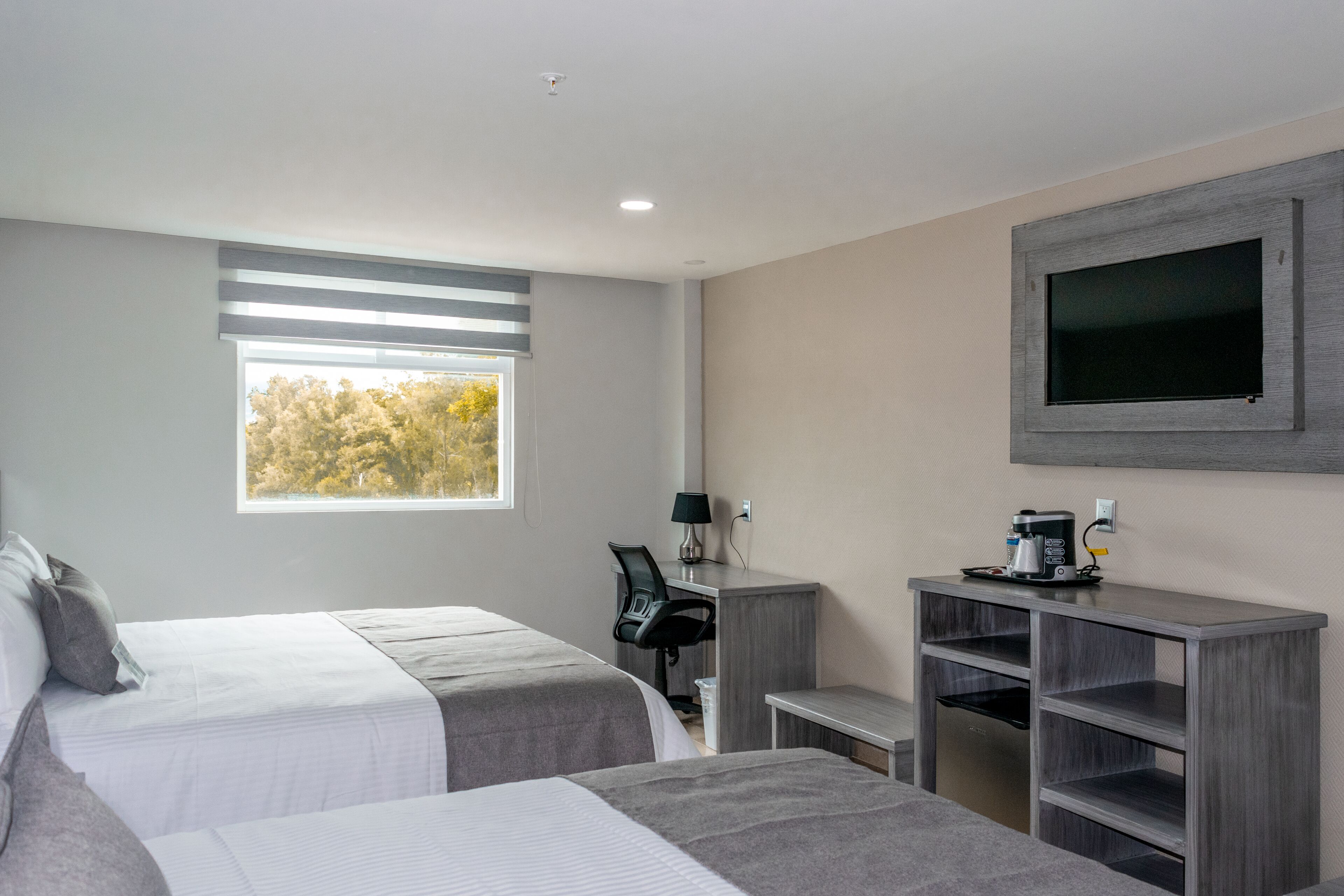 deluxe room, multiple beds | minibar, in-room safe, desk, blackout curtains
