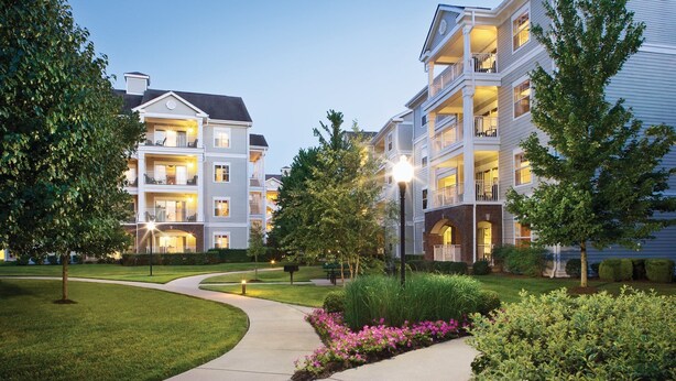 A multi-story residential building with balconies, a landscaped garden, and a pathway. - Country Music's finest Modern Resort by Grand Ole Opry & Convention Center (Nashville)