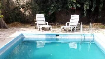 Outdoor pool, open 7:30 AM to 10:00 PM, pool loungers