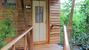 A wooden structure with a wooden staircase leading to a door marked "BAYE". - Eskapo Verde Lodge Moalboal (Badian)