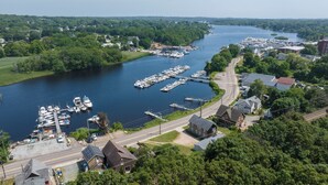 A marina with boats docked, surrounded by residential buildings and greenery. - Waterfront Cottage - Mystic, Westerly, Stonington Beaches and Casinos Nearby (Stonington)