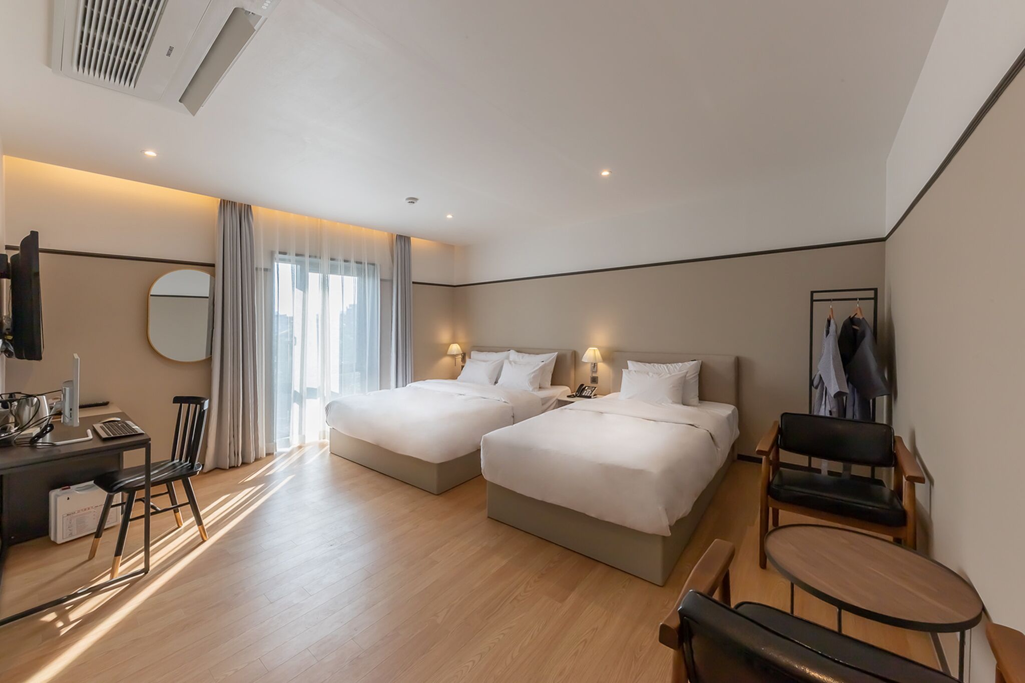 deluxe twin room | down duvets, tempur-pedic beds, desk, laptop workspace