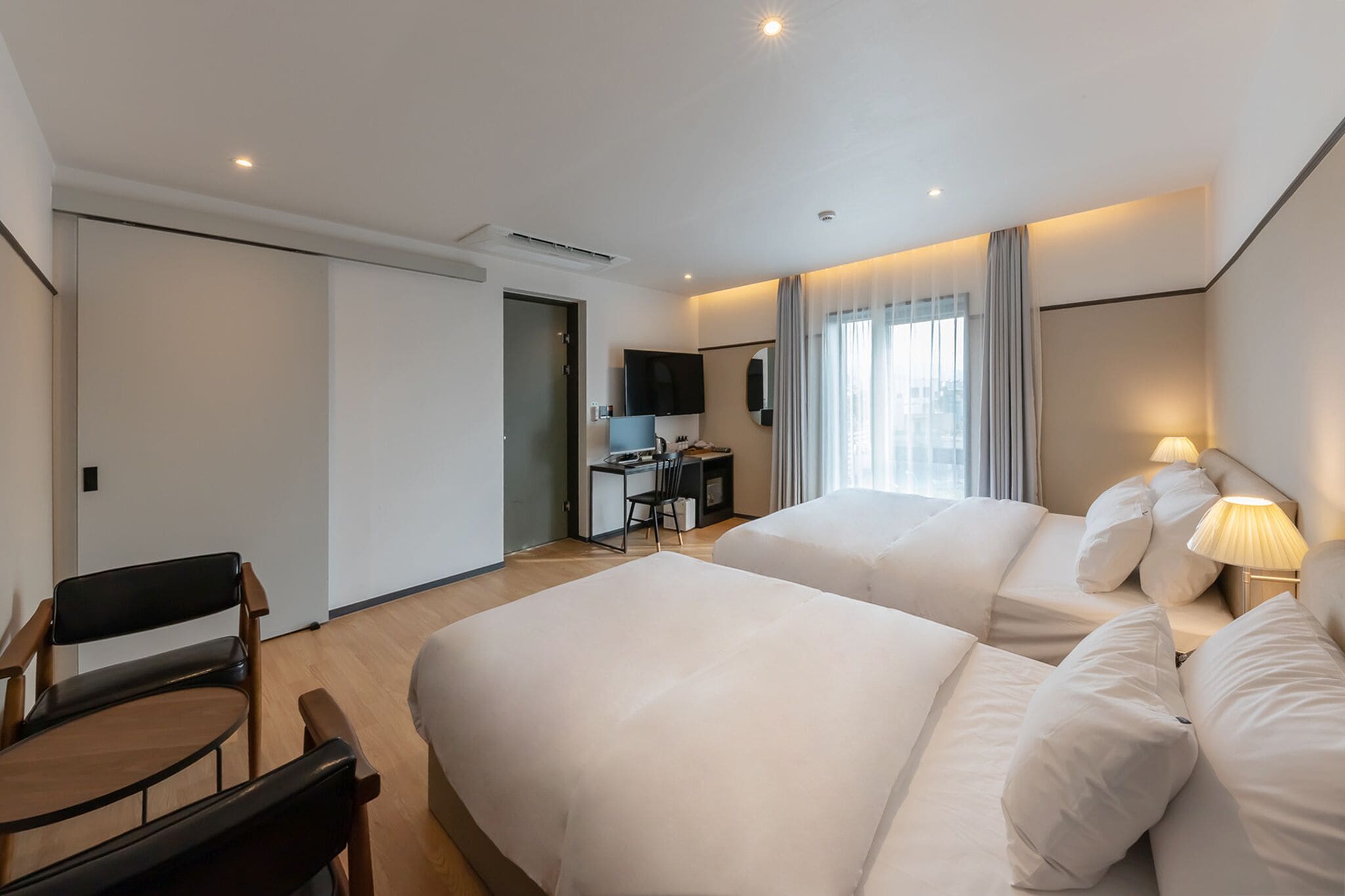 deluxe twin room | down duvets, tempur-pedic beds, desk, laptop workspace