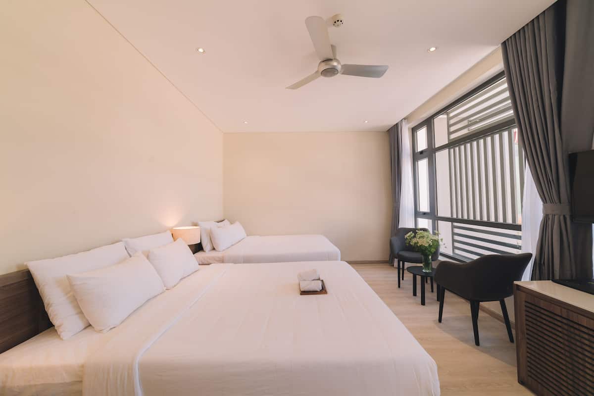 Deluxe Quadruple Room, Non Smoking | Premium bedding, individually furnished, desk, blackout drapes