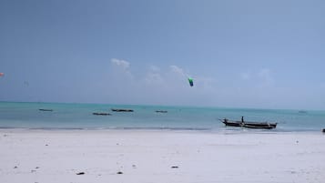 On the beach, white sand, sun-loungers