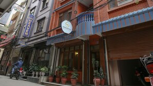 A hotel with a sign reading "SIDDHARTHA HOTEL" and a closed shutter on the right. - Siddhartha Hotel Sundhara (Kathmandu)