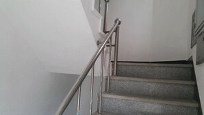 A staircase with metal handrails and carpeted steps.
