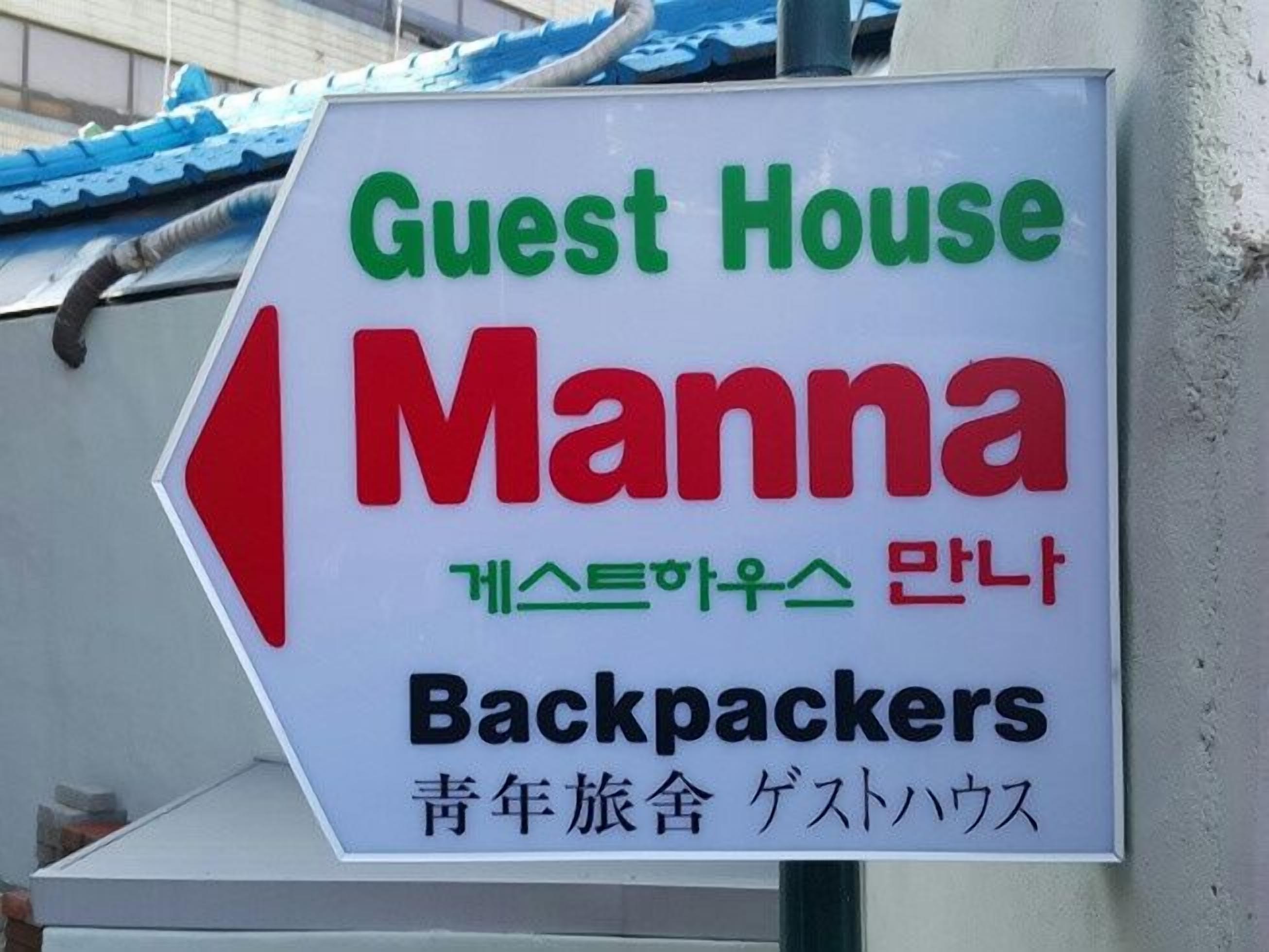 A sign for a guest house named Manna, indicating it is for backpackers.