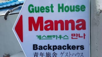 A sign for a guest house named Manna, indicating it is for backpackers.