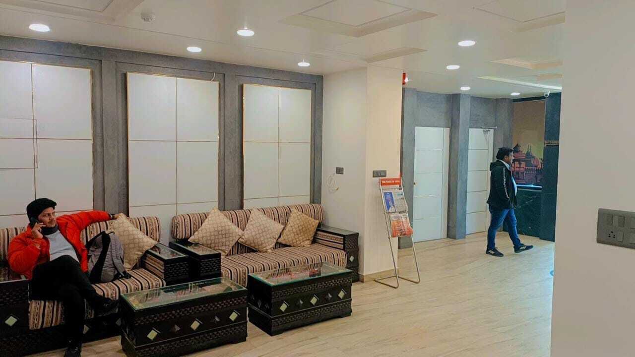 A lobby with a sofa, coffee table, and a reception desk.