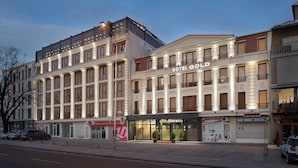 A multi-story hotel with a classic facade, large windows, and a prominent "HOTEL GOLD" sign. - Hotel Gold (Skopje)