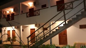 A multi-level building with a staircase, multiple doors, and wall-mounted lights. - 27 Cafe Zanzibar Airport Hotel (Zanzibar Town)