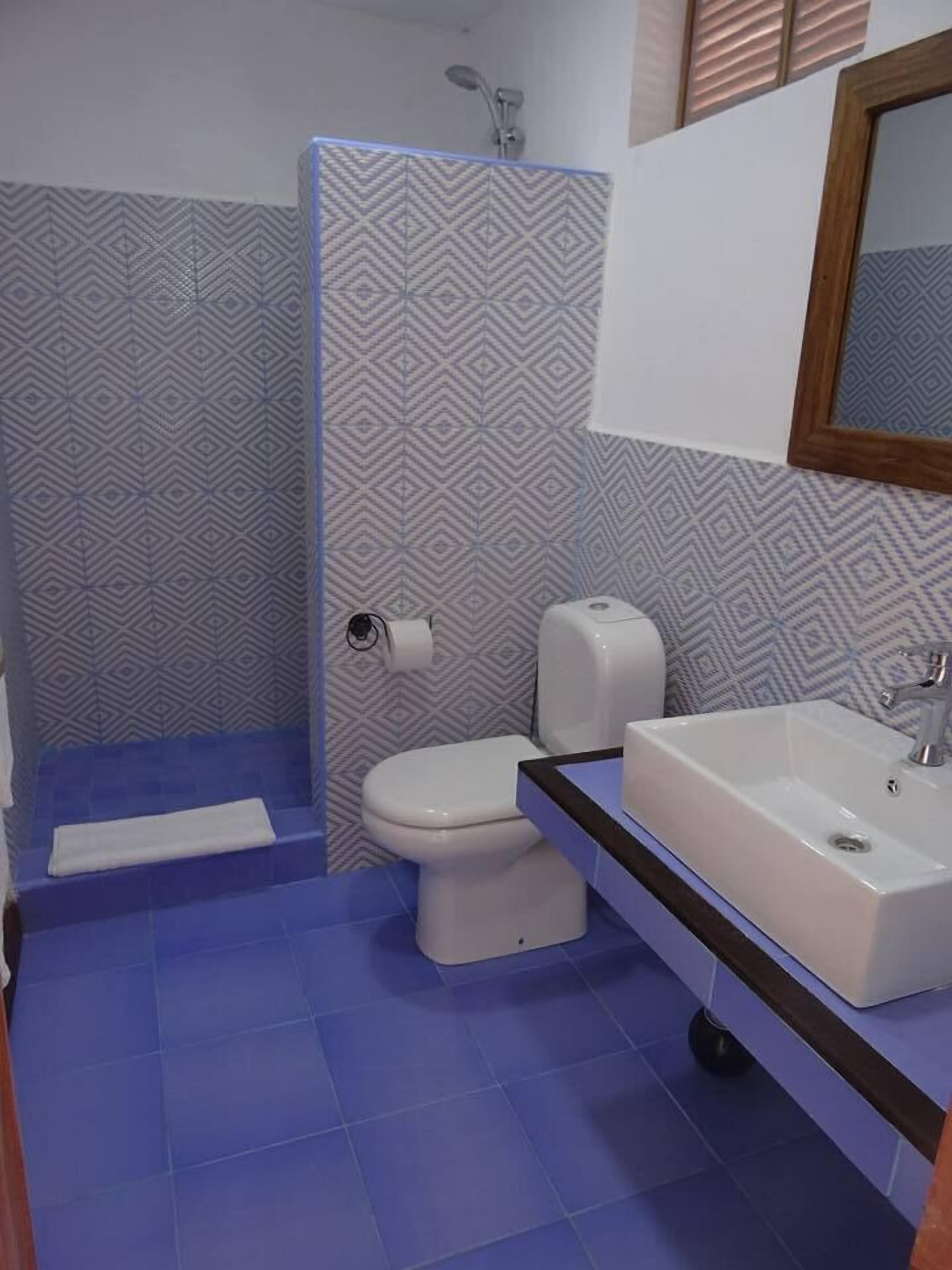 deluxe quadruple room | bathroom | shower, free toiletries, hair dryer, towels