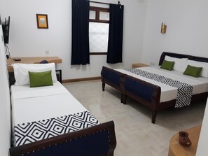 A hotel room with two beds, a wooden bench, a small table, a window with curtains, and a wall-mounted light fixture. - 27 Cafe Zanzibar Airport Hotel (Zanzibar Town)