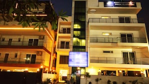 A multi-story hotel with a sign for "Maven's White" and "Rooms & Banquet for Special Celebrations." - Mavens White Artemis Hospital Road Gurgaon (Gurugram)