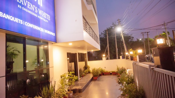 A modern building with a sign reading "Maven's White" and mentions banquets, conferences, and workspace. - Mavens White Artemis Hospital Road Gurgaon (Gurugram)