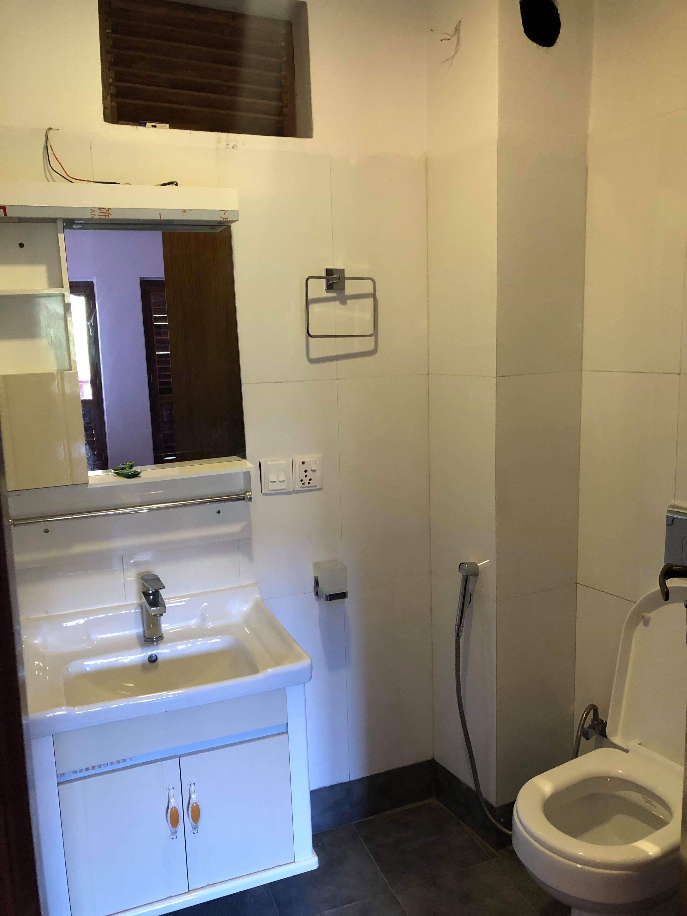 Shower, rainfall showerhead, slippers, towels