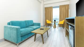 Junior Suite | Living area | 32-inch flat-screen TV with cable channels