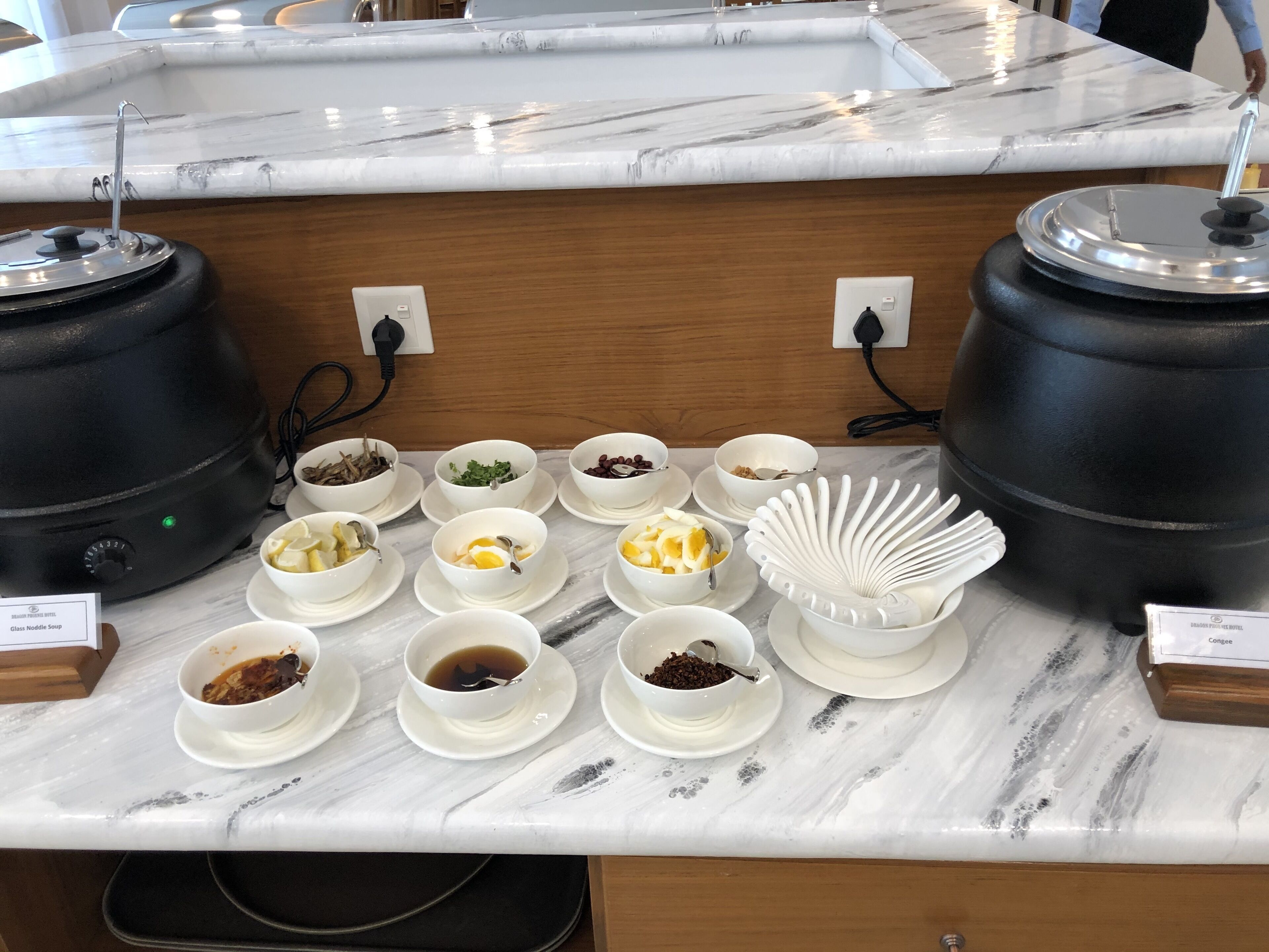 A buffet setup with various dishes and a coffee station.