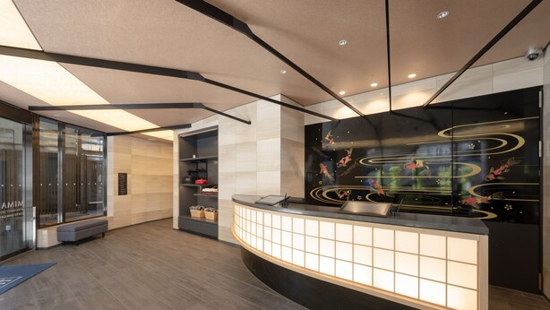 A modern reception area with a curved reception desk, a glass partition, and a decorative wall with abstract designs. - MIMARU Tokyo Shinjuku West (Tokyo)