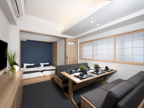 A compact hotel room with a bed, a small seating area, a dining table, and a large window with a view. - MIMARU Tokyo Shinjuku West (Tokyo)