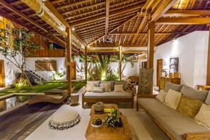 Cozy seating area with a sofa, cushioned bench, and wooden coffee table.