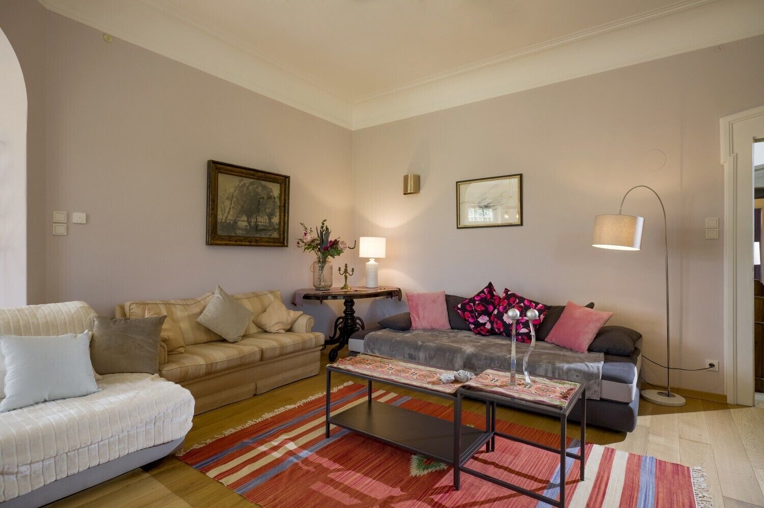A living room with two sofas, a coffee table, and a floor lamp.