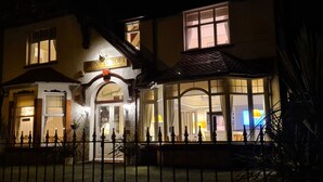 A two-story building with a sign reading "Sunnycroft Guest Accommodation." - Sunnycroft Guesthouse (Llandudno)
