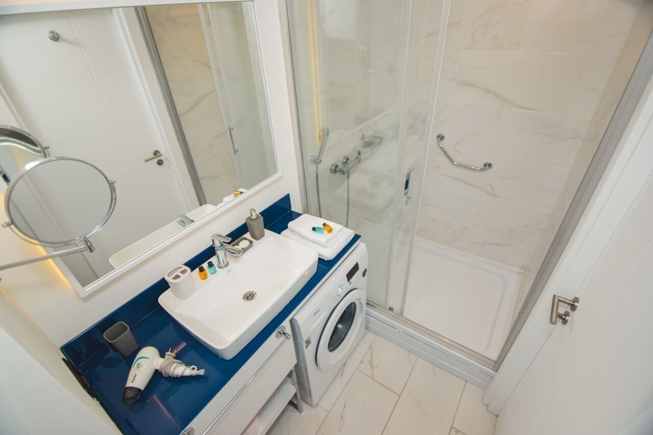 Ein Badezimmer mit Waschbecken, Spiegel und Dusche.