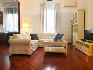 Apartment, 1 Bedroom | Living room | 28-inch TV with satellite channels - JOIVY Wooden Guerrini Apartment (Milan)