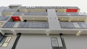 A multi-story building with the sign "YOYOTOWNHOUSE" indicating a hotel. - Hotel Aravali Inn & Banquet Hall (Faridabad)