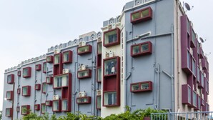 A multi-story building with a unique architectural design featuring rectangular windows and balconies.