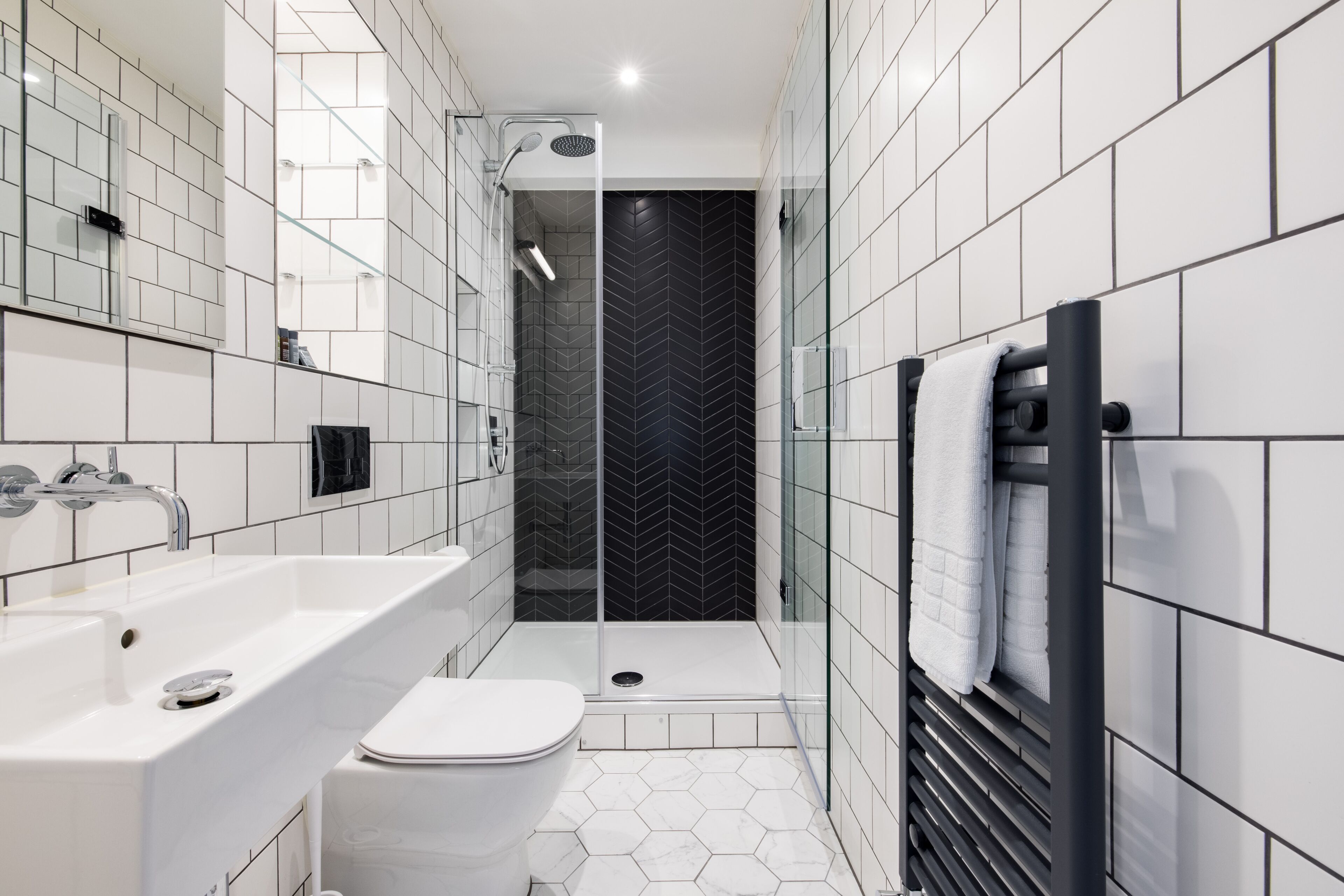 standard suite | bathroom | rainfall showerhead, free toiletries, hair dryer, heated floors