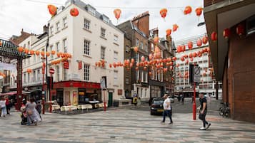 A street with buildings, a pedestrian crossing, and red lanterns.